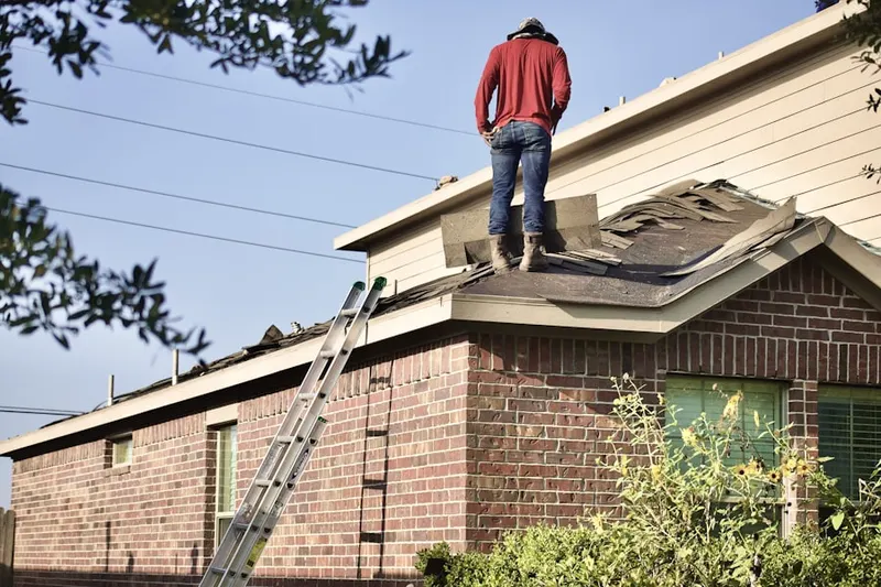 Professional roofer working on a residential roof in Elkwood